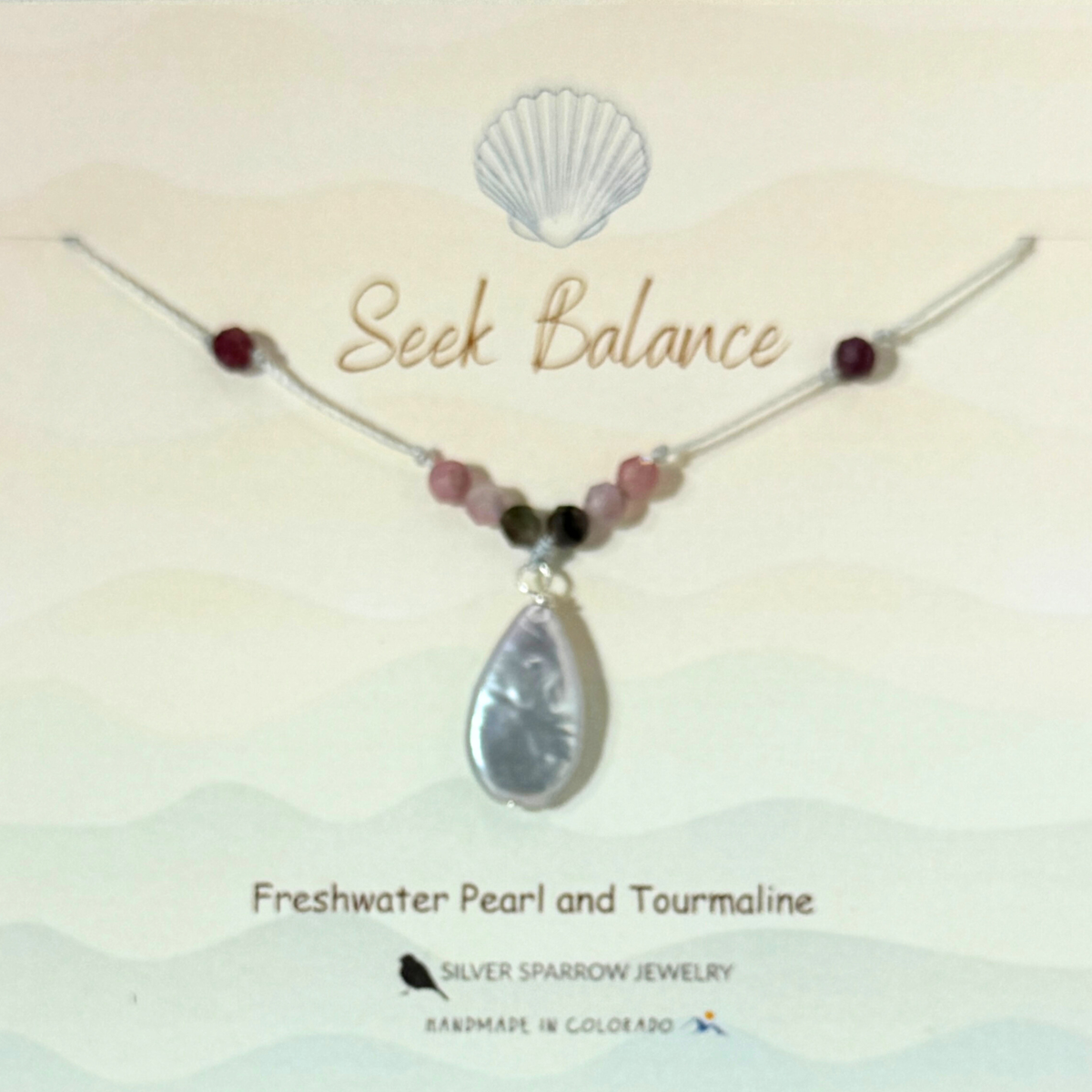 Freshwater silver teardrop pearl with tourmaline