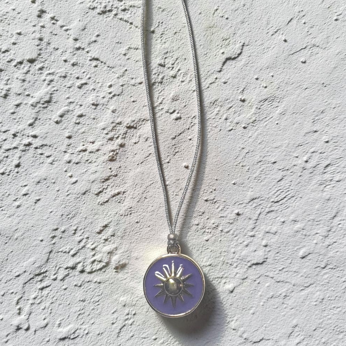 Neon purple enamel sun necklace