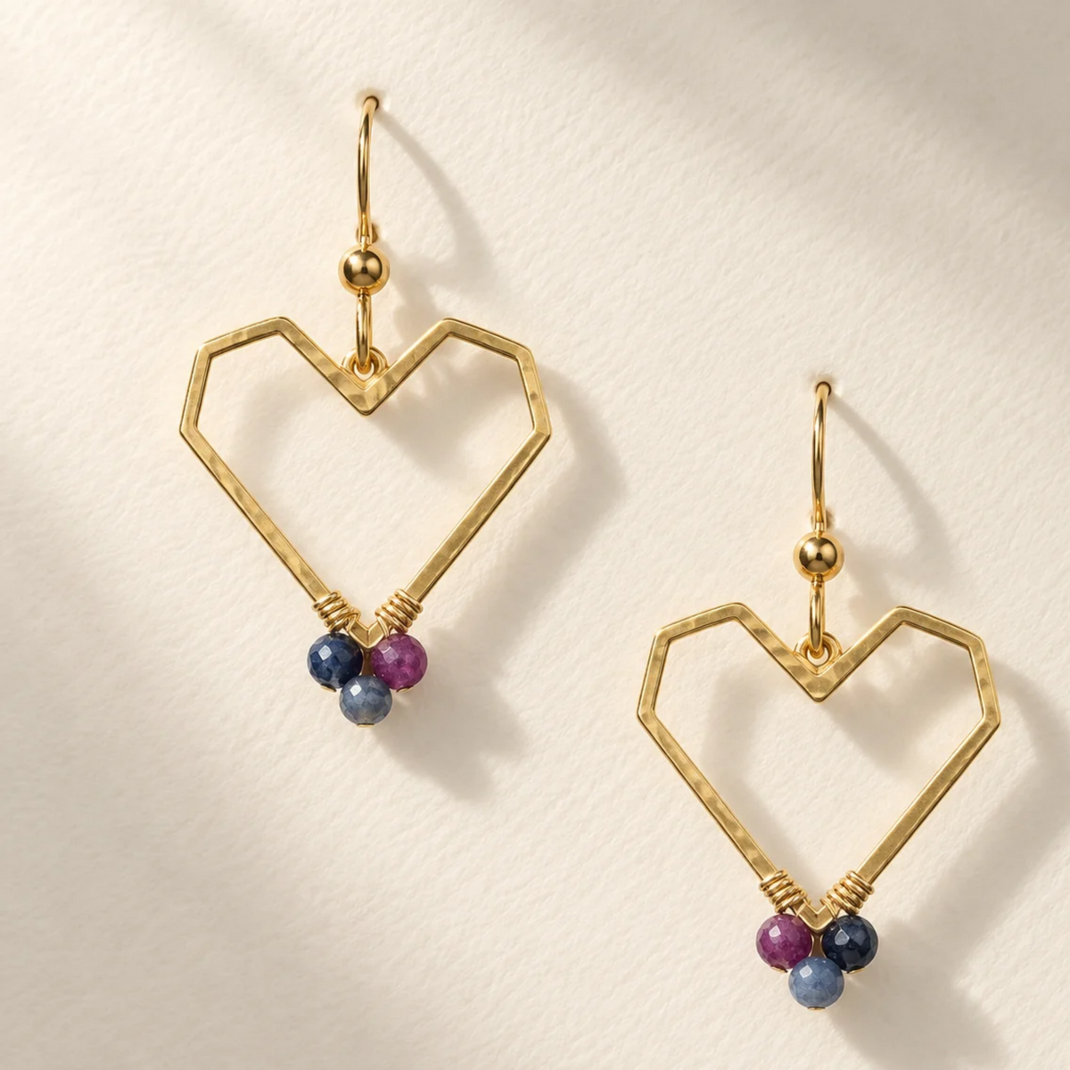 Golden heart earring with sapphire
